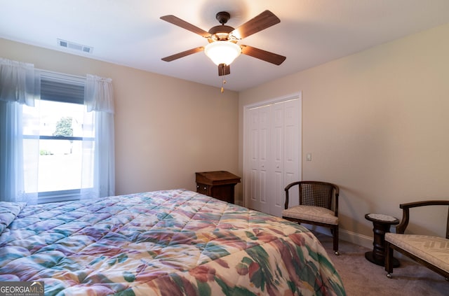 carpeted bedroom with a closet and ceiling fan