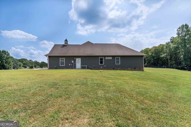 back of house with a lawn