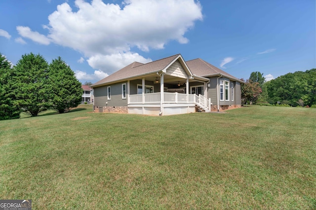 back of house featuring a yard, a porch, and ceiling fan