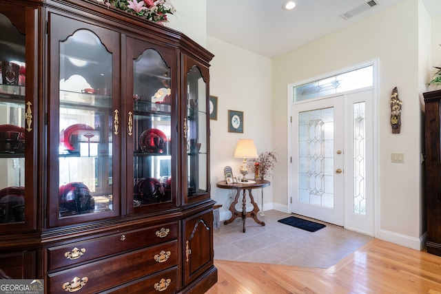 foyer entrance with light wood-type flooring