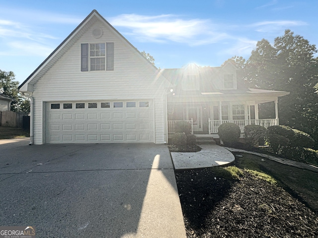 view of front facade with a porch, a garage, and driveway