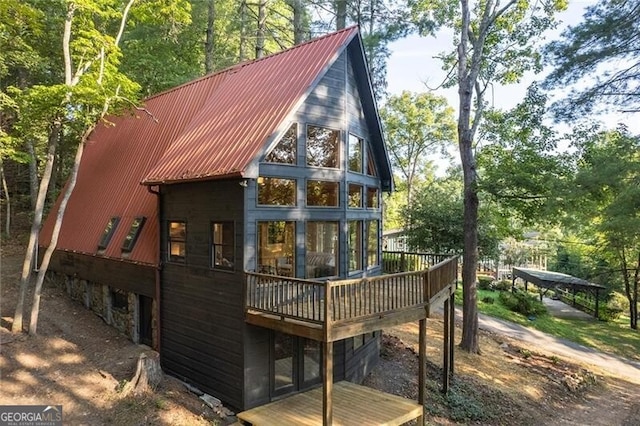 rear view of property with a wooden deck