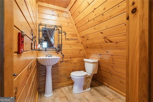 bathroom featuring toilet, wood walls, wooden ceiling, lofted ceiling, and hardwood / wood-style flooring