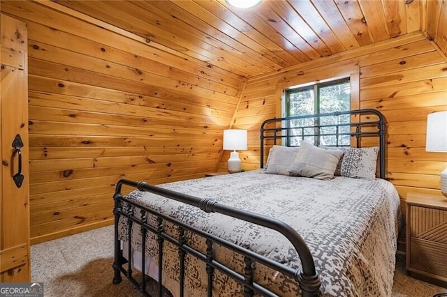 bedroom with wood ceiling, wooden walls, and carpet floors