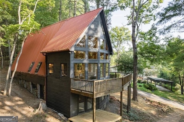 back of property featuring a wooden deck