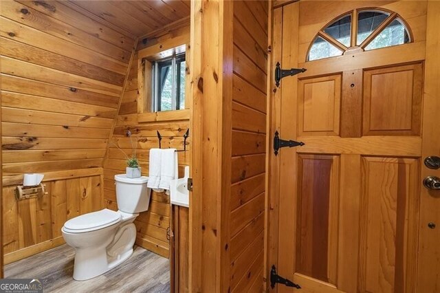 bathroom featuring wooden ceiling, toilet, lofted ceiling, wood-type flooring, and wood walls