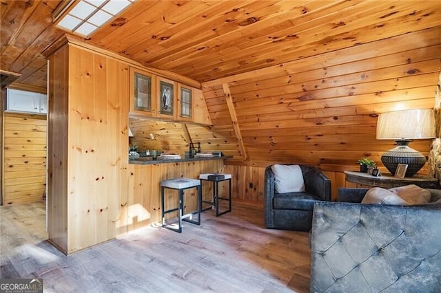 living area featuring wood ceiling, lofted ceiling, wood-type flooring, and wood walls