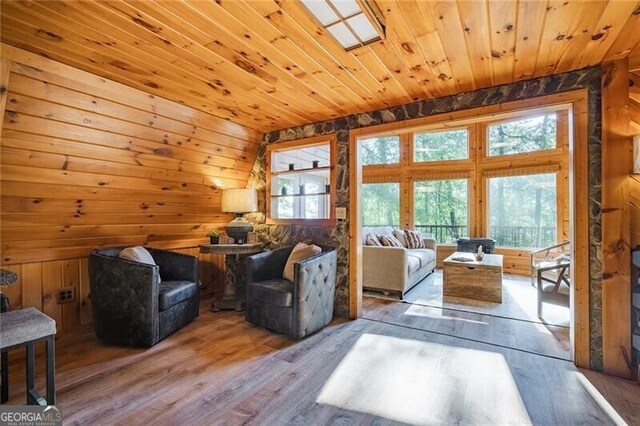 living room with wood ceiling, vaulted ceiling, wooden walls, and hardwood / wood-style flooring