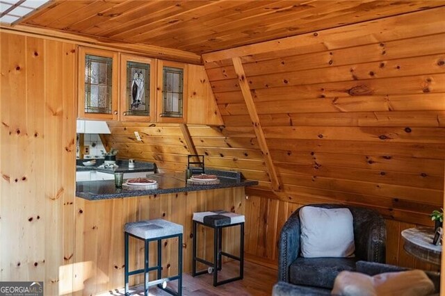 interior space with hardwood / wood-style floors and wood walls