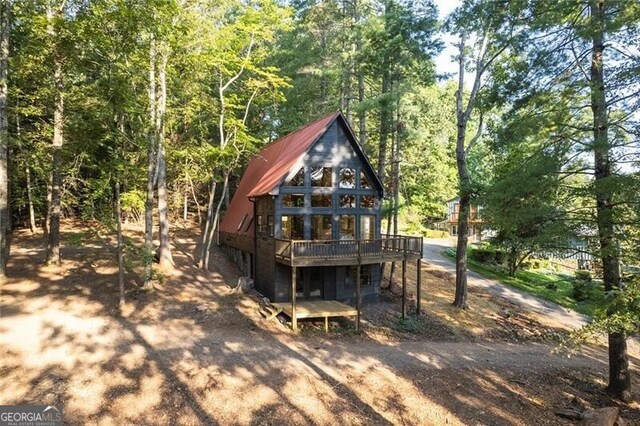 rear view of house featuring a deck