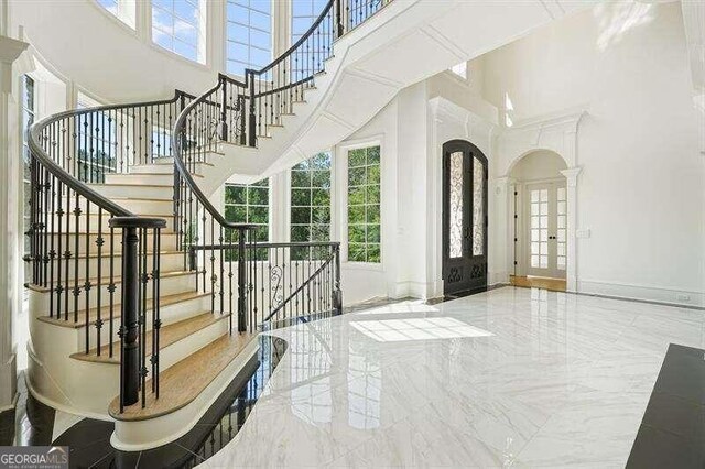 foyer with french doors and a high ceiling