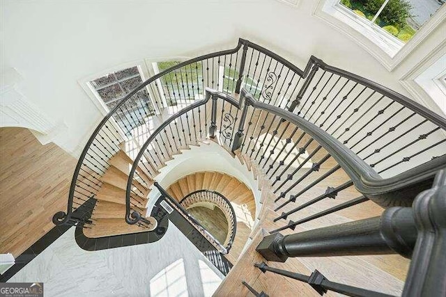 stairway featuring a towering ceiling