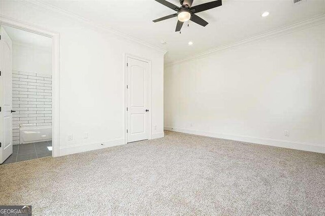 unfurnished bedroom with ensuite bath, ornamental molding, ceiling fan, and carpet floors