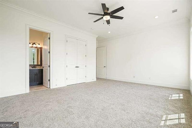 unfurnished bedroom featuring ceiling fan, ornamental molding, light carpet, and ensuite bathroom