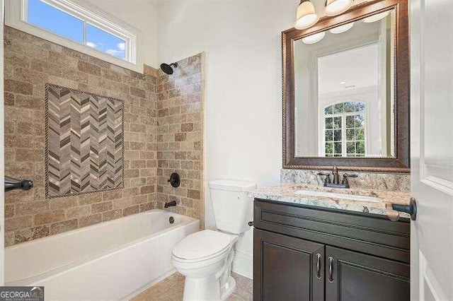 full bathroom featuring plenty of natural light, toilet, tiled shower / bath combo, and vanity