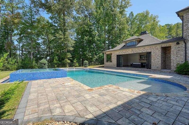 view of swimming pool with a patio area