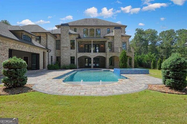 view of pool featuring a patio area, a yard, and pool water feature