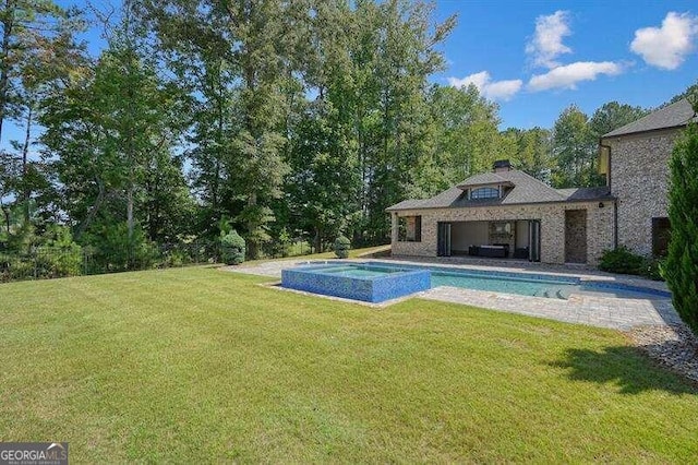 view of swimming pool with a lawn, a patio area, and an in ground hot tub