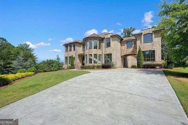 french country style house featuring a front yard