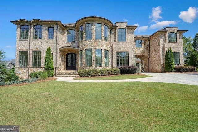 french provincial home with a front yard