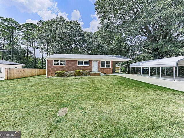 view of front of property with a front yard and a carport