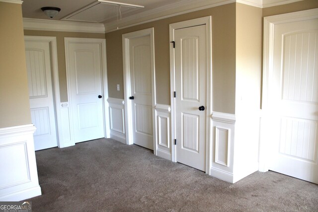 unfurnished bedroom featuring dark carpet and crown molding