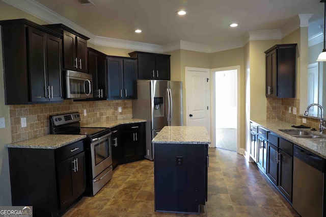 kitchen with backsplash, stainless steel appliances, sink, pendant lighting, and a center island