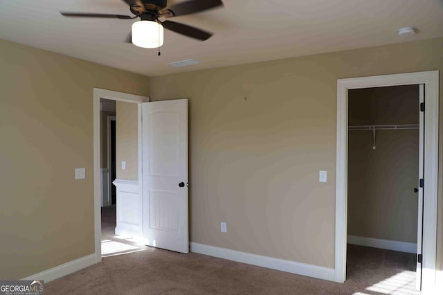 unfurnished bedroom with ceiling fan, a closet, and light colored carpet