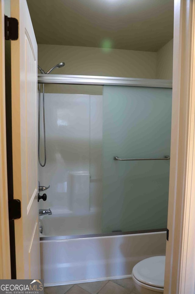 bathroom featuring tile patterned floors, shower / bathtub combination, and toilet