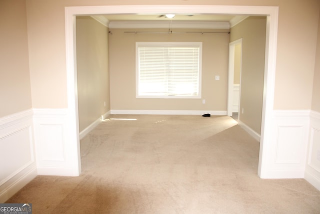 carpeted empty room featuring ornamental molding