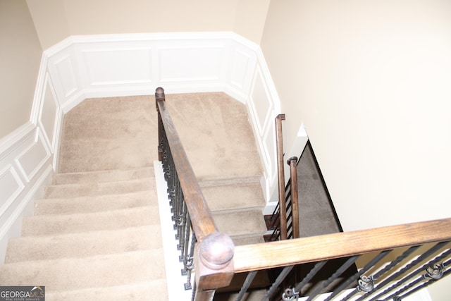 stairs featuring carpet flooring