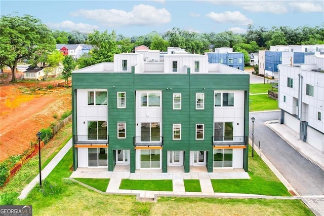 rear view of property with a yard