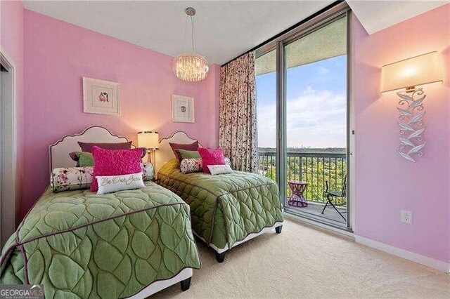 bedroom with access to outside, a notable chandelier, and carpet floors