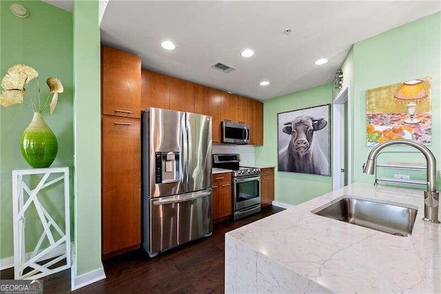 kitchen featuring appliances with stainless steel finishes, sink, and dark hardwood / wood-style floors