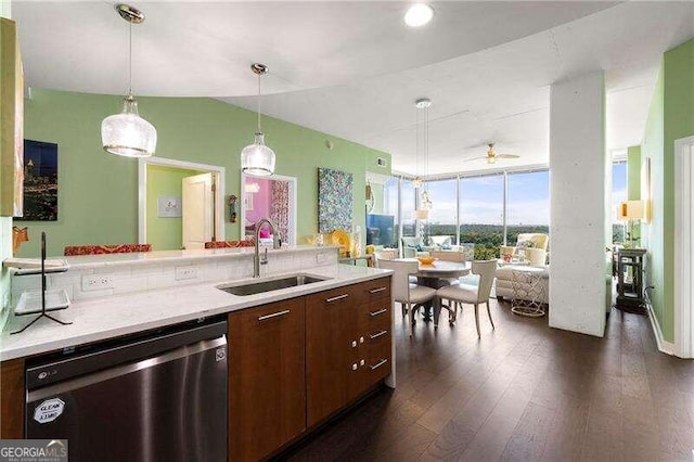 kitchen with dishwasher, sink, dark brown cabinets, dark hardwood / wood-style floors, and pendant lighting