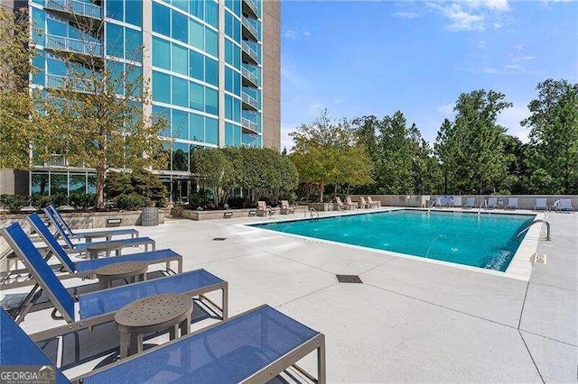 view of swimming pool featuring a patio area