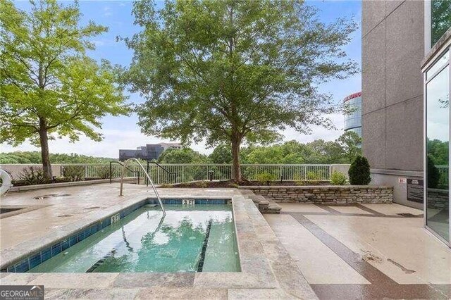 view of swimming pool with a patio area