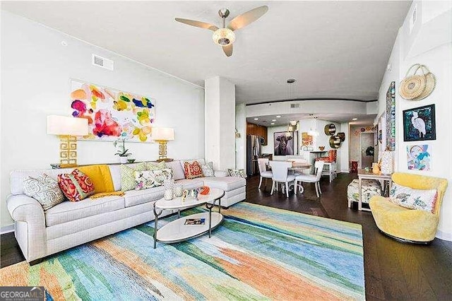 living room with ceiling fan and hardwood / wood-style flooring