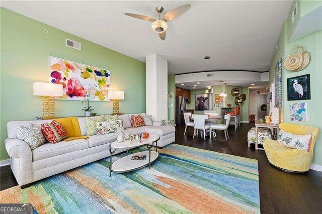 living room featuring hardwood / wood-style flooring and ceiling fan