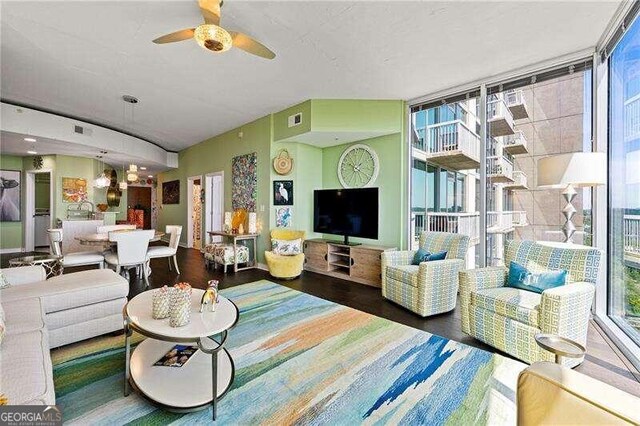 living room featuring floor to ceiling windows, ceiling fan, and dark hardwood / wood-style floors