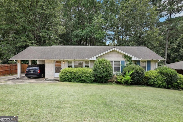 single story home featuring an attached carport, brick siding, fence, and a front lawn