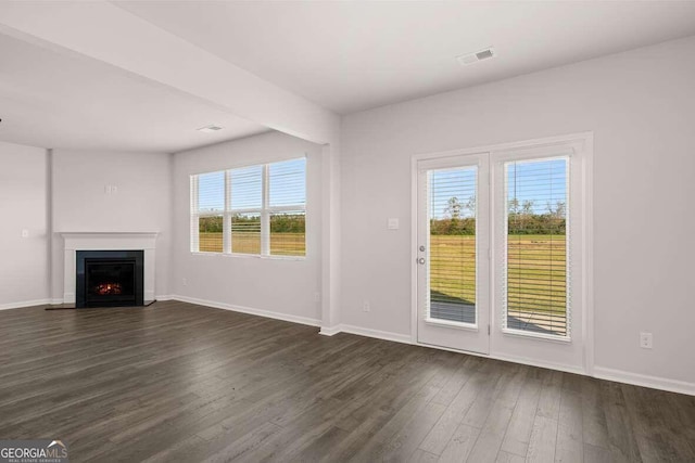 unfurnished living room featuring dark wood-type flooring