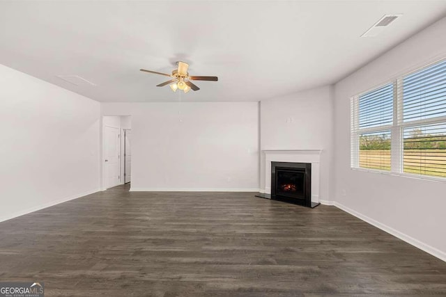 unfurnished living room featuring ceiling fan and dark hardwood / wood-style flooring