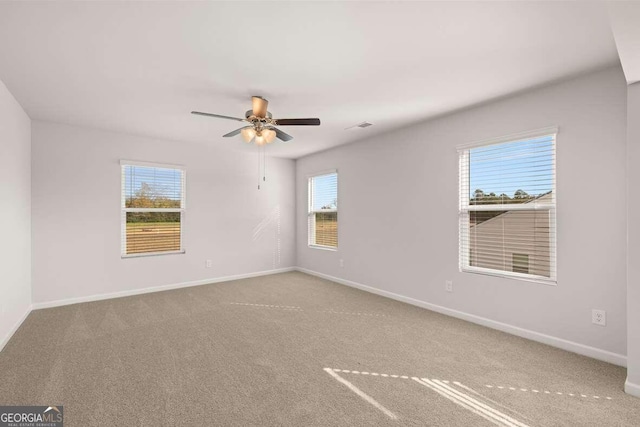 carpeted empty room with ceiling fan