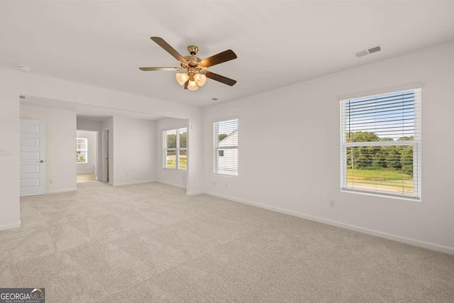 empty room featuring light colored carpet and ceiling fan