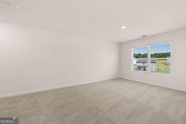 unfurnished room with light colored carpet