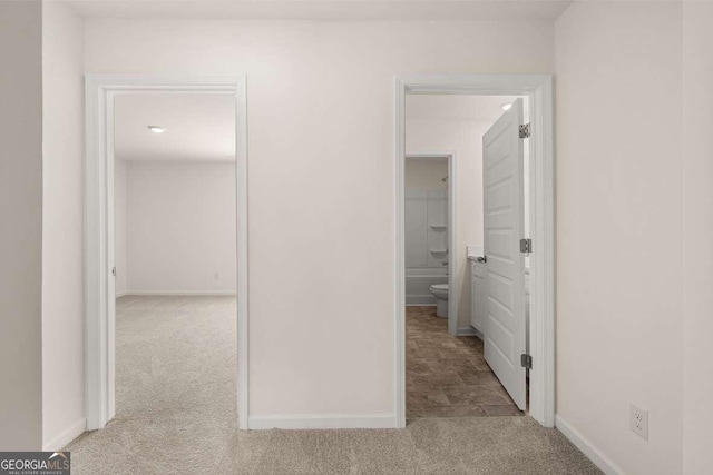 hallway with light colored carpet