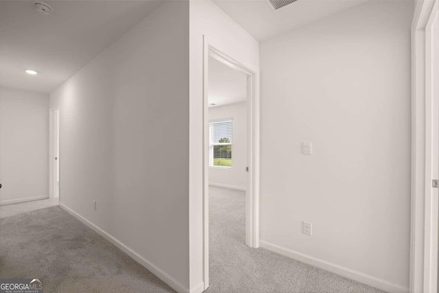 hallway with light colored carpet