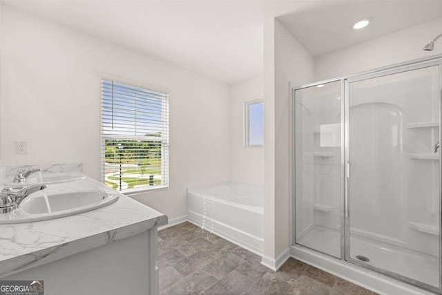 bathroom with vanity and separate shower and tub