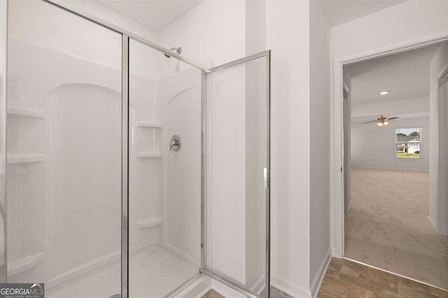 bathroom with walk in shower and ceiling fan